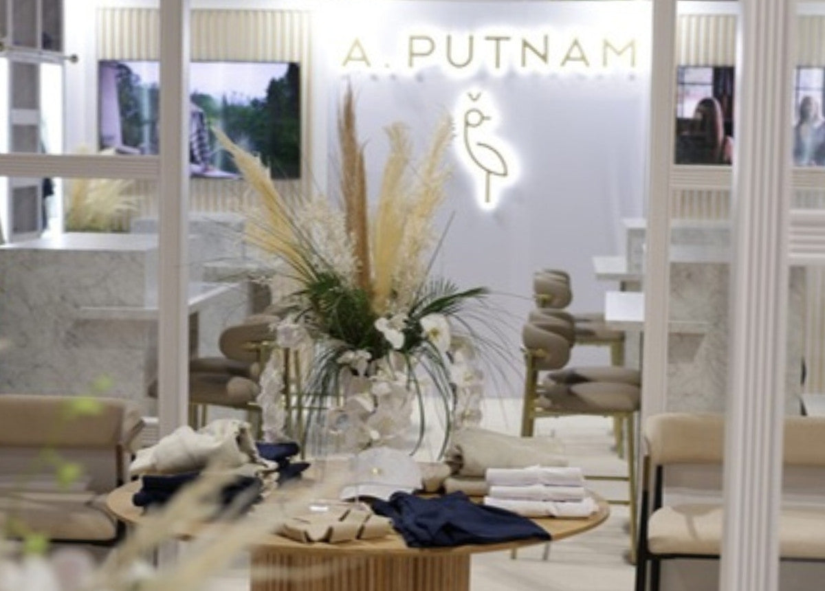 The A. PUTNAM booth at the PGA Show, with the crane logo lit on the wall
